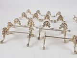 six pairs of silver plated figurines on a white background