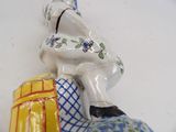 a figurine of a man sitting on top of a suitcase