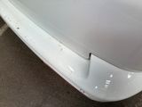 a close up of a car ' s front bumper with rust on it
