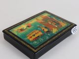 an image of a small wooden box with a painting on it