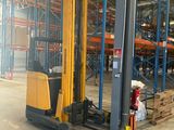 a forklift in a warehouse with pallets and boxes
