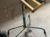a small table with wheels on it in a garage
