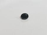 a single black diamond on a white surface