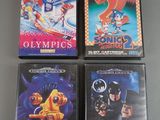 three nintendo games are on a table with a gray background