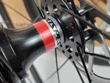 a close up of a bicycle wheel with a red hub