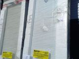 many mattresses stacked up on a pallet in a warehouse