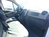 the interior of a white van with black seats and a steering wheel