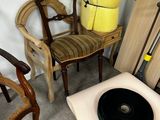 several chairs and a table in a room with a yellow vase