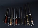 several different types of knives are lined up on a black surface