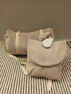 deux sacs posés sur un tapis rayé