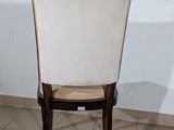 a white chair with a beige seat in a room