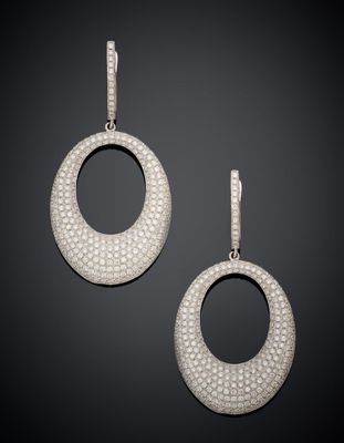 a pair of diamond and white gold earrings