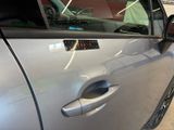 a silver car with a sticker on the side of it