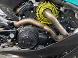 a close up of a motorcycle engine with a yellow wheel