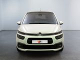the front view of a white citrole parked in a white room