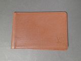 a brown leather wallet sitting on top of a table