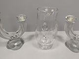 three glass vases that are sitting on a table