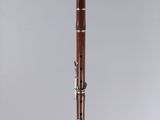 an old bassoon on a clear surface with a white background