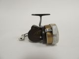 a close up of a fishing reel on a white surface