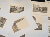 several black and white photos of a bunch of buildings on a table