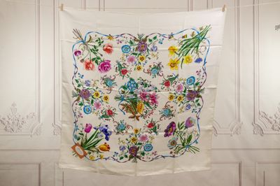 a white wall with a colorful floral design on it
