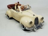 a toy car with a dog in the back of it