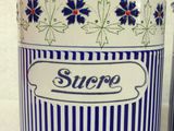 two blue and white canisters with blue flowers on them