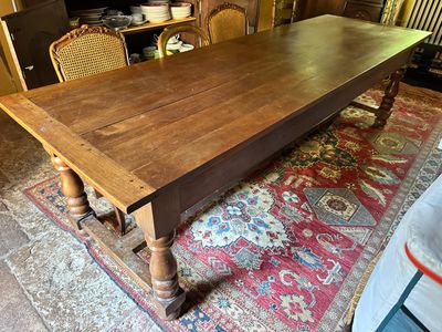 a large wooden table in the middle of a living room
