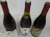 three bottles of wine sitting next to each other on a table