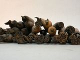 a pile of carved animal heads on a white surface