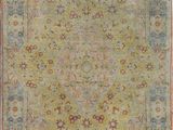 an antique rug with a green field and red border