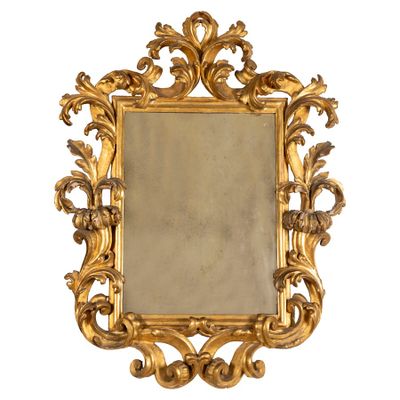 une image d'un miroir encadré d'or sur un fond blanc