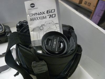 a bag with a camera and a camera lens in it