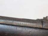 an old gun with a wooden barrel and a metal handle