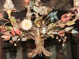 a chandelier with a bunch of flowers hanging from it