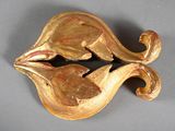 a gold brooch with two birds on it
