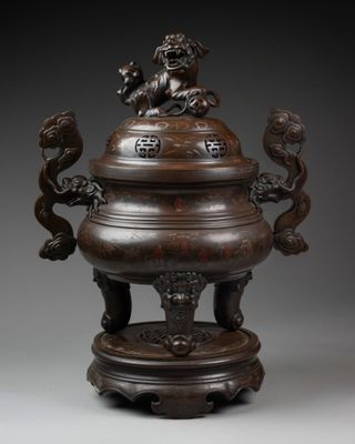 a large bronze incense vessel with lions on top of it