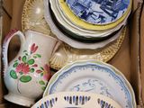 a box full of china plates and bowls in it