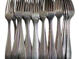 six forks that are sitting next to each other on a table