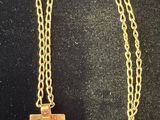 a gold plated necklace with a square pendant on a chain