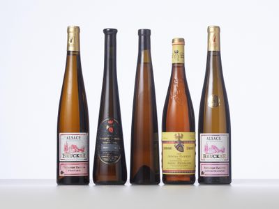 four bottles of wine are lined up on a table
