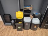 many trash cans and bins in this room