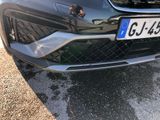 a close up of a car ' s front bumper with a number plate on it