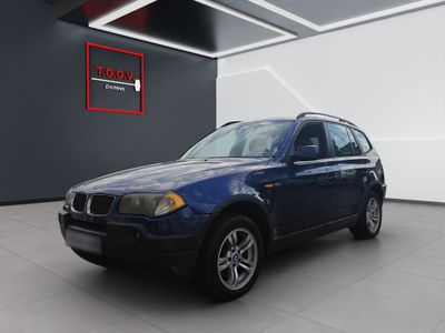 La BMW X3 est garée dans le garage du showroom d'un concessionnaire.