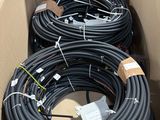 a box full of black hoses in a cardboard box