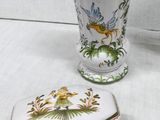 two vases and a box sitting on a table