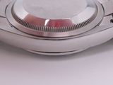 a close up of a watch on a white surface