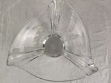 a clear glass bowl with a silver lid on a table