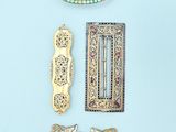 a lot of different pieces of jewelry on a blue surface
