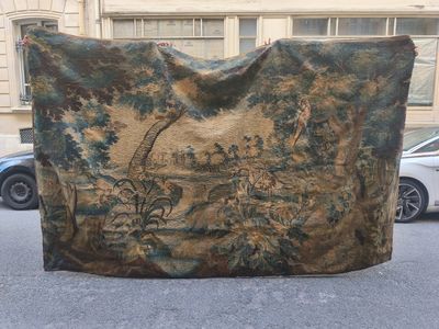 a large tapestry hanging on the side of a building